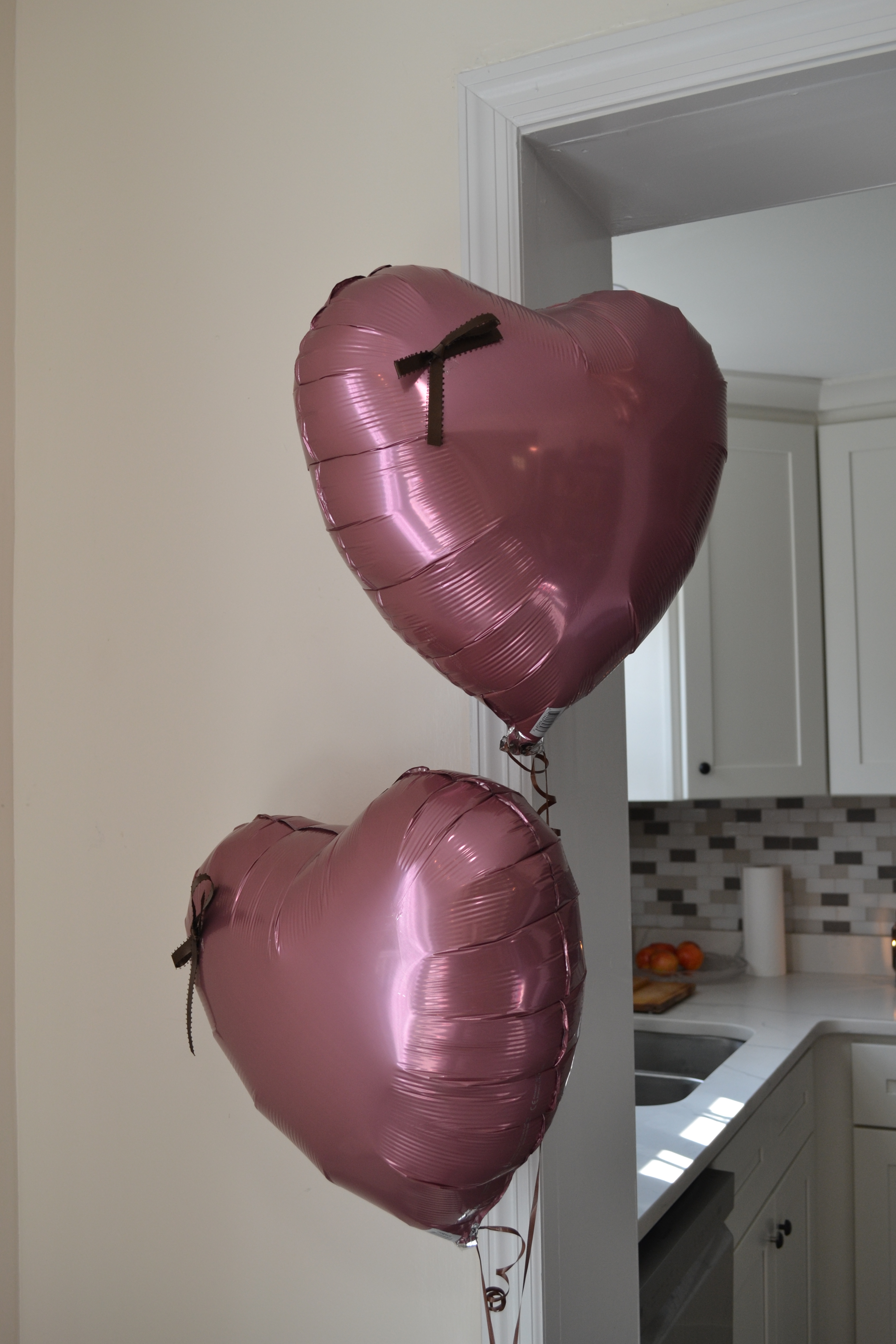 mauve heart foil balloons with brown bows