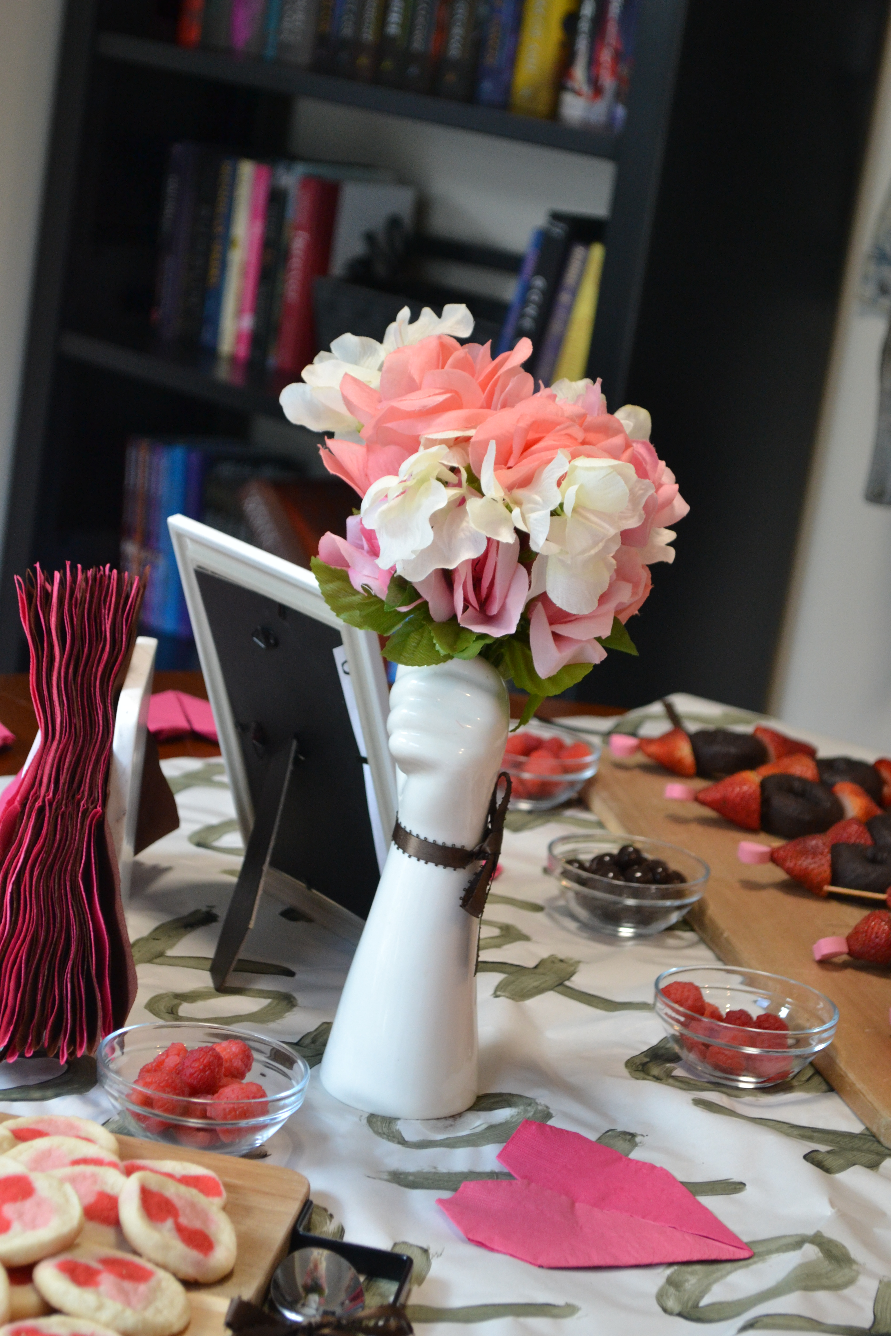 valentine's day brunch table of bacon, muffins, and cookies