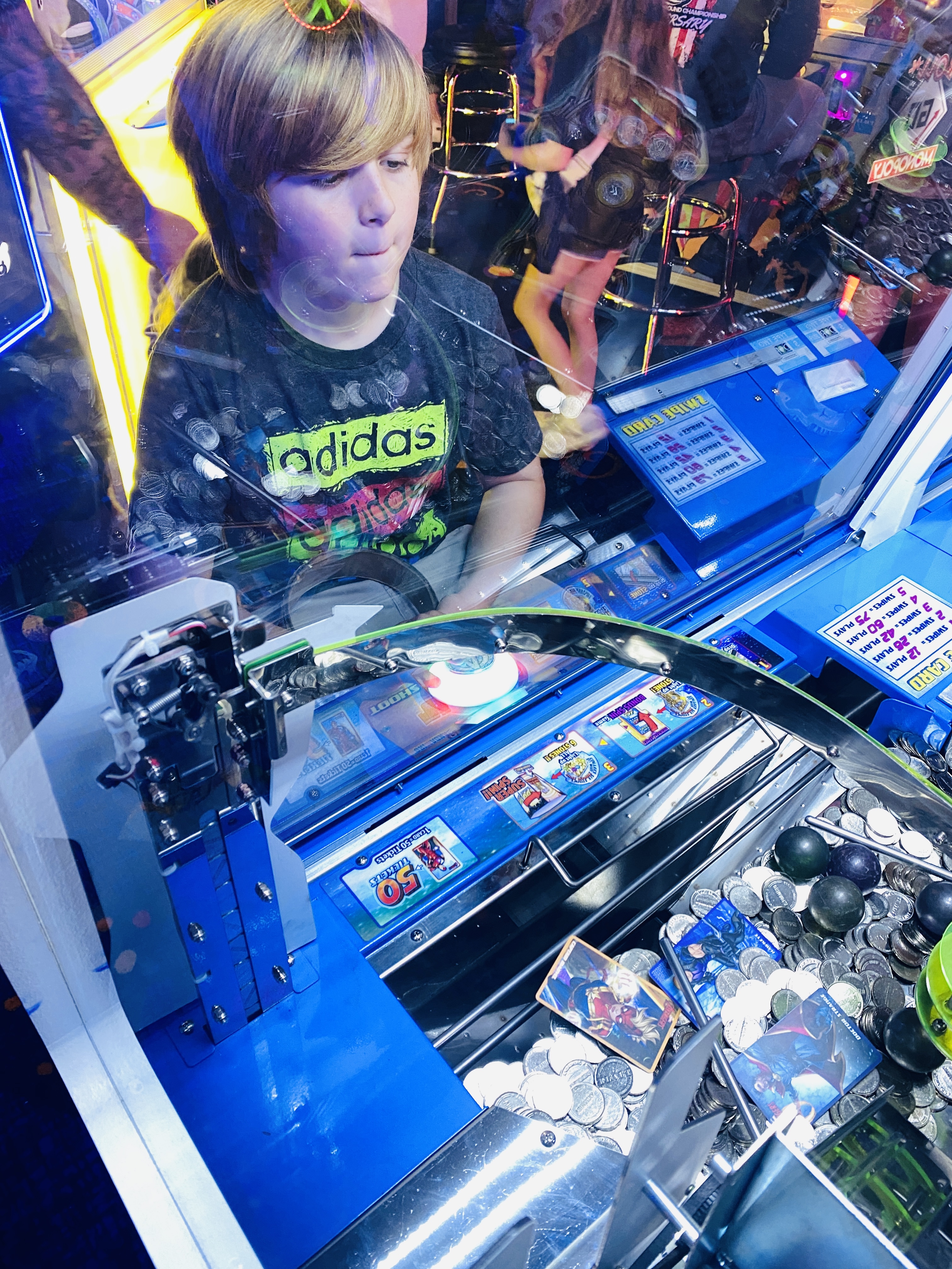 Nephew Playing Coin Shooter Game