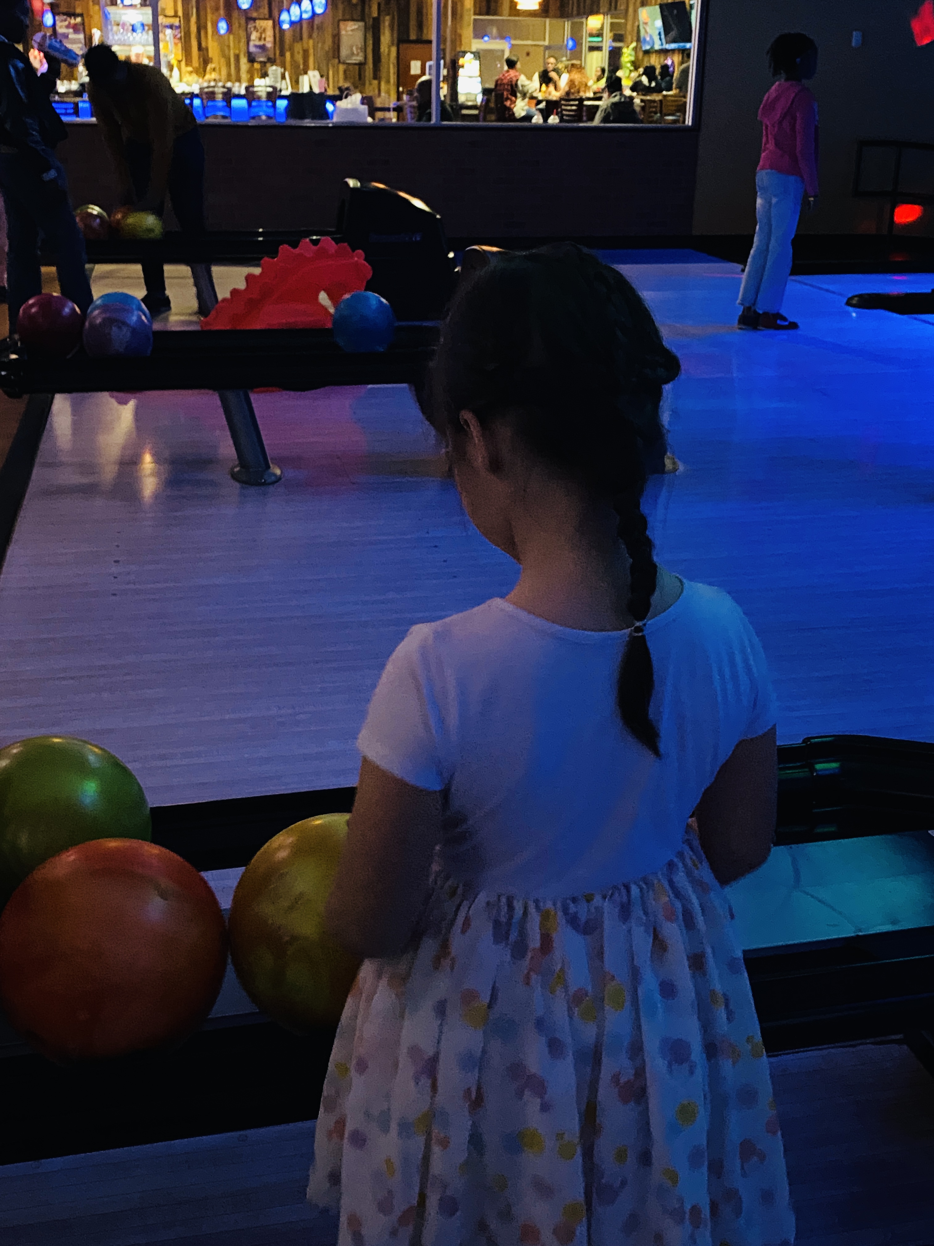 Niece Getting the Bowling Ball from the Return